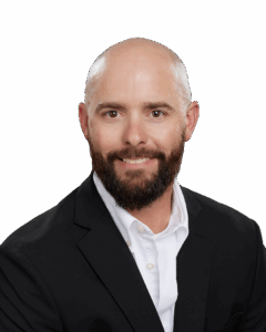 Kelly_Everett_Oct 2021 A bearded man in a white shirt and black blazer