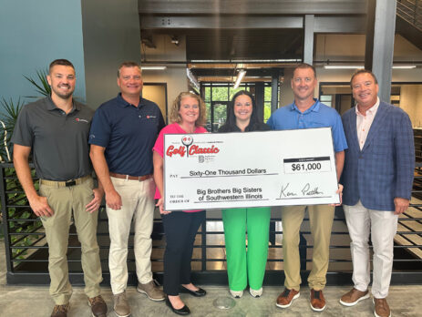 Men and women holding an oversized check