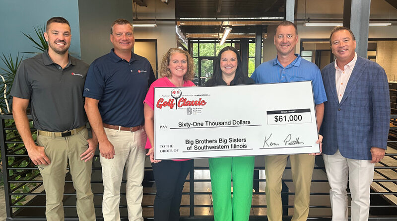 Men and women holding an oversized check