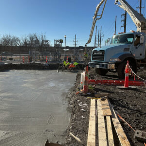 Markets-Berkeley-Substation-1000x1000 Construction workers next to a concrete truck smooth a freshly poured concrete pad